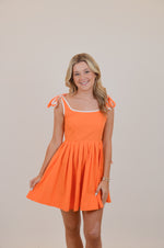 Orange Dress with Bows and White Trim
