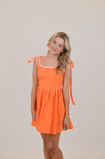 Orange Dress with Bows and White Trim