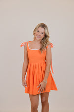 Orange Dress with Bows and White Trim
