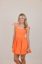 Orange Dress with Bows and White Trim