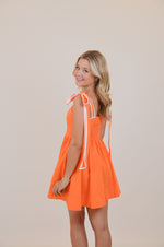 Orange Dress with Bows and White Trim